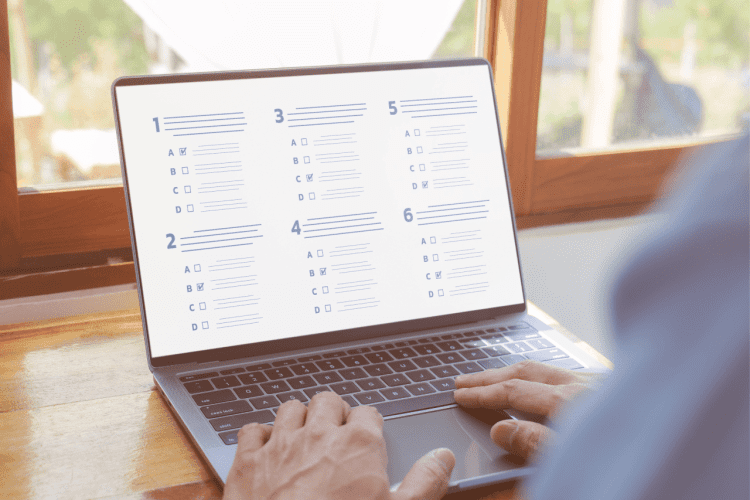 hands , laptop screen displaying exams grading