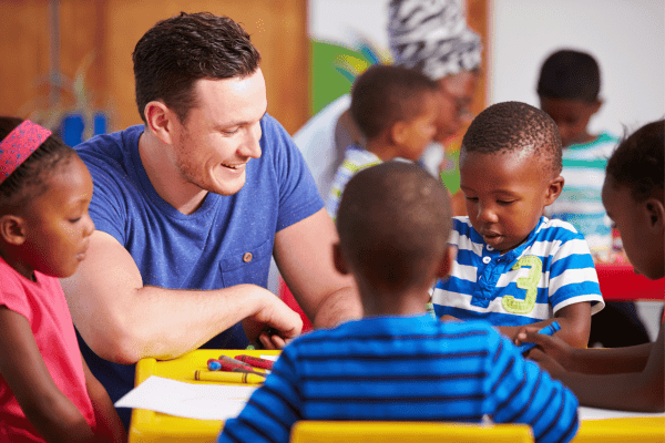 Advancing Educational Equity with AI: Bridging the Learning Gap male teacher , students , tables , crayons